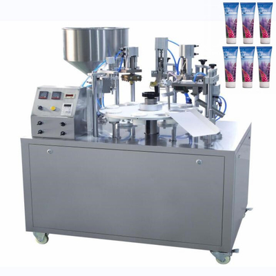 Machine de remplissage et d'étanchéité des tubes mous de pommade cosmétique rotative